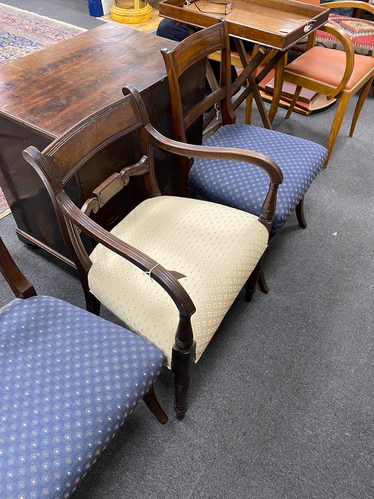 A late Sheraton mahogany elbow chair and a pair of Sheraton mahogany single chairs